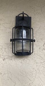 An outdoor wall lantern with a cage design, installed by Goodie's Electrical Contractors LLC in Dothan, AL