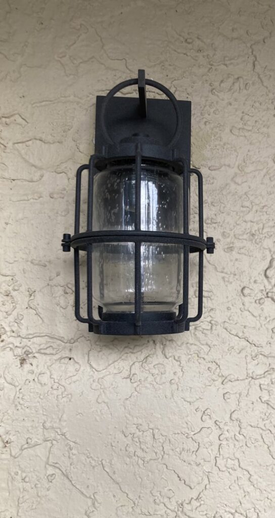 An outdoor wall lantern with a cage design, installed by Goodie's Electrical Contractors LLC in Dothan, AL