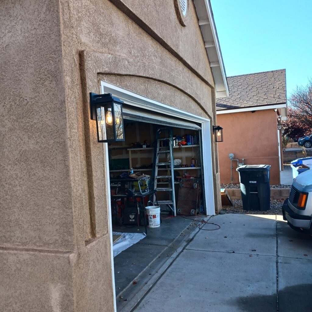 Newly installed outdoor wall lanterns illuminating a garage by Calhoun Electric Inc. in Rio Rancho, NM
