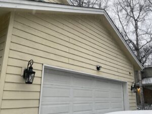 Exterior of a house with newly installed outdoor wall lights by Intel-electric in Anchorage, AK