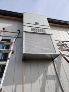 An outdoor wall-mounted HVAC unit with ladders nearby, installed by HP Mechanical LLC in Santa Rosa, CA.