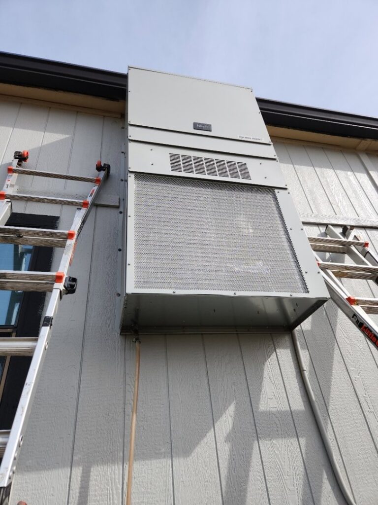 An outdoor wall-mounted HVAC unit with ladders nearby, installed by HP Mechanical LLC in Santa Rosa, CA.