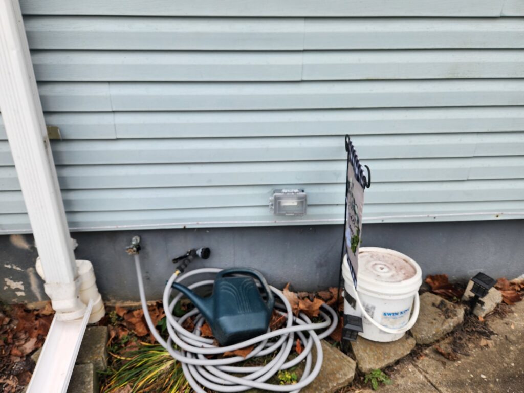 A newly installed outdoor weatherproof electrical outlet on a house siding, a service provided by Rylix Electric in Cincinnati, OH.