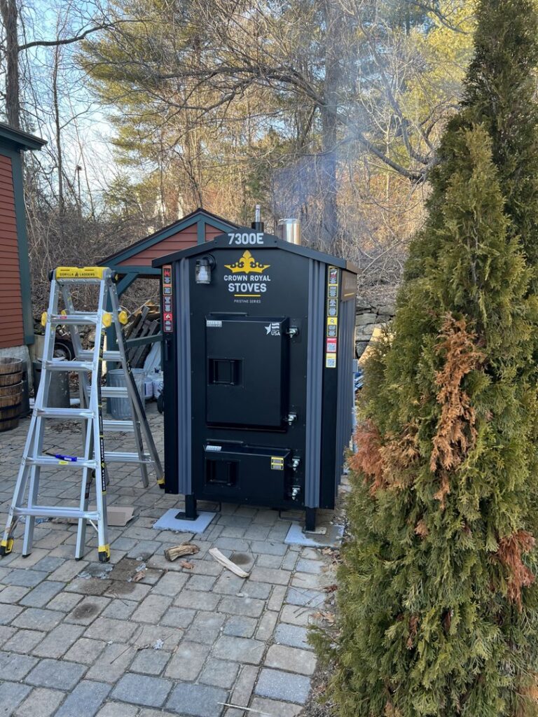 An outdoor wood furnace or boiler installation by Quality Comfort Inc. in Aston, PA