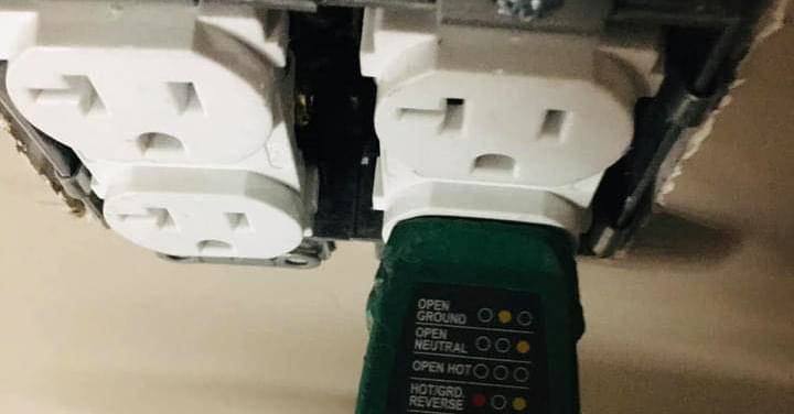 An electrician uses an outlet tester to check wiring for faults at Granados Electric LLC in Chandler, AZ.