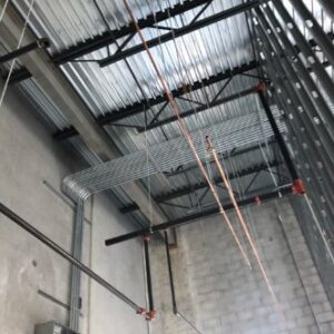 Overhead electrical conduit installation in a commercial building by Tri-Area Electrical Construction in Cape Coral, FL.