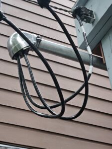 Overhead electrical service connection and conduit installation on a building by JAL Electrical Construction in Hammond, IN.