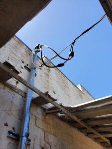 Overhead exterior electrical conduit and wiring installed on a building by TJS Electrical Services Inc in Mesa, AZ.