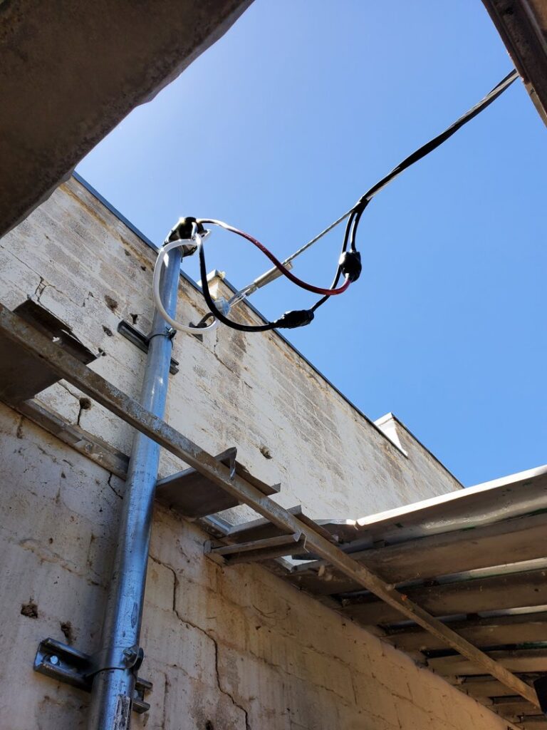 Overhead exterior electrical conduit and wiring installed on a building by TJS Electrical Services Inc in Mesa, AZ.