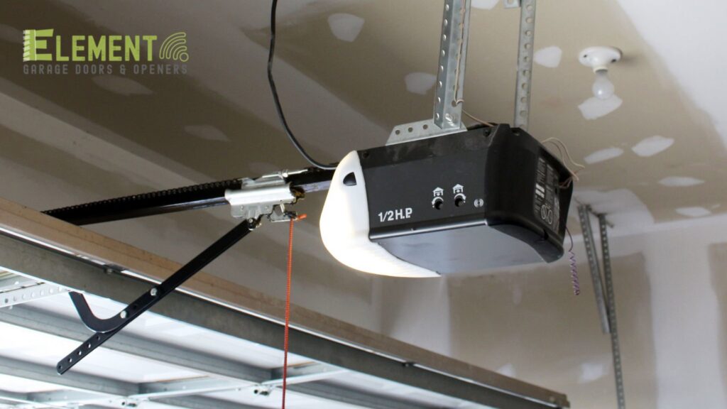 An overhead garage door opener installed on a ceiling, demonstrating professional installation by Element Garage Door Repair Of Portland, OR