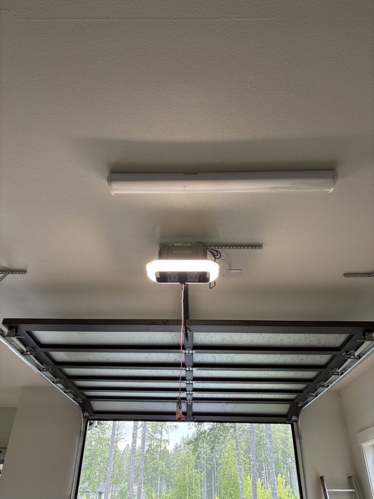 An overhead view of a garage door opener system and tracks, installed by Rainier Garage Door for homes in Bellevue, WA.