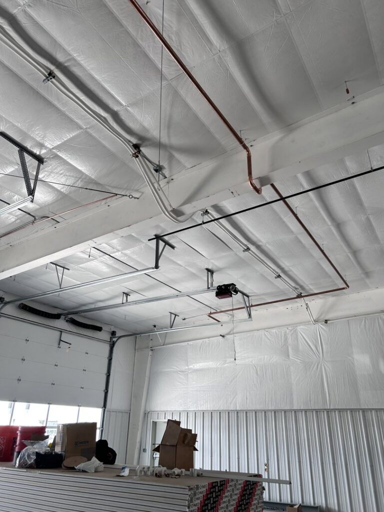 Overhead HVAC piping and ductwork installed in a commercial building by KCC Mechanical, LLC in Sandy, UT.