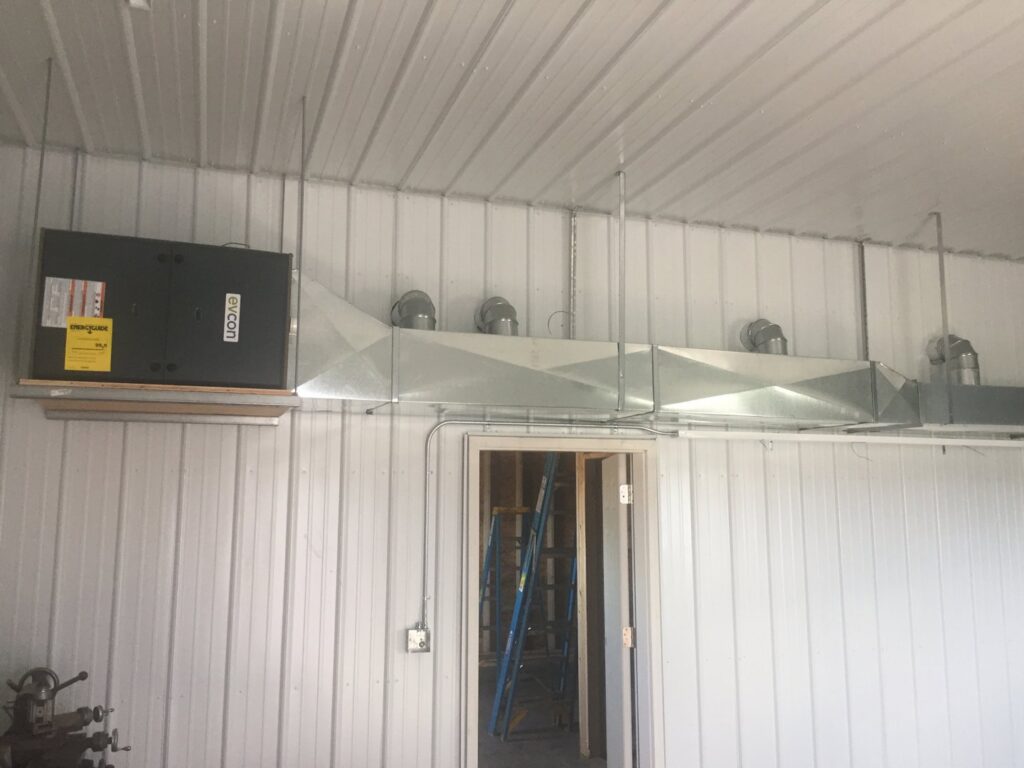 An overhead HVAC unit and ductwork system installed in a commercial space by Butte Heating & Cooling in Rapid City, SD.