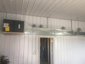 An overhead HVAC unit and ductwork system installed in a commercial space by Butte Heating & Cooling in Rapid City, SD.