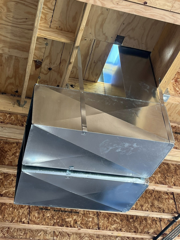 Overhead metal HVAC ductwork installation in a building under construction by Airman Solutions Inc in Oklahoma City, OK