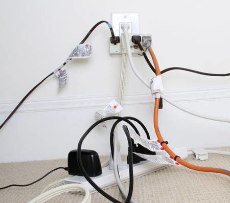 An overloaded electrical outlet with multiple cords, a hazard addressed by Your Electrician in Yakima, WA.