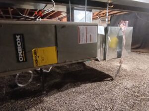 An Oxbox HVAC furnace unit installed in a crawl space or basement, showing work by TAS Mechanical Services in Kearney, MO.