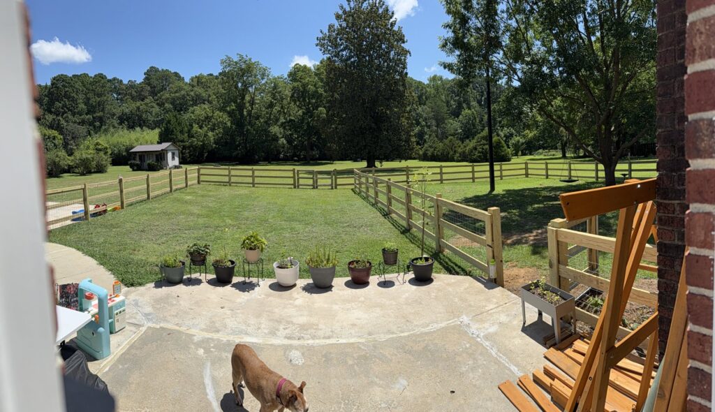 A panoramic view of a wood split-rail fence with wire mesh installed by Fence & Custom Gatework LLC in Columbia, SC