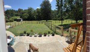 A panoramic view of a wood split-rail fence with wire mesh installed by Fence & Custom Gatework LLC in Columbia, SC
