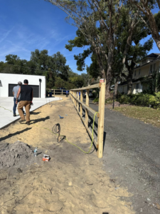 A partially built wooden split rail fence installation by North East Fence and Forestry in North Bay, ON.