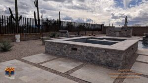 A dark metal snake fence with a block base enclosing a patio area, installed by Arizona Snake Fence LLC in Tucson, AZ