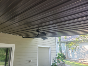 A modern ceiling fan installed on an outdoor patio ceiling by BIG Services in Springfield, MO.