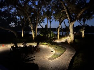 Illuminated patio and pathway with landscape lighting installed by Wirenut Technologies LLC in Brandon, FL.