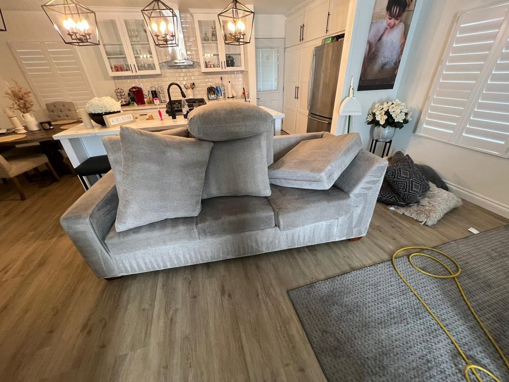 A cleaning hose on a patterned area rug during a professional cleaning service by GTS future cleaning services in Los Angeles, CA