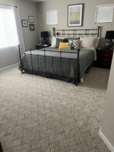 A bedroom featuring a newly installed patterned carpet by Hatloes Carpet One Floor & Home in Everett, WA.