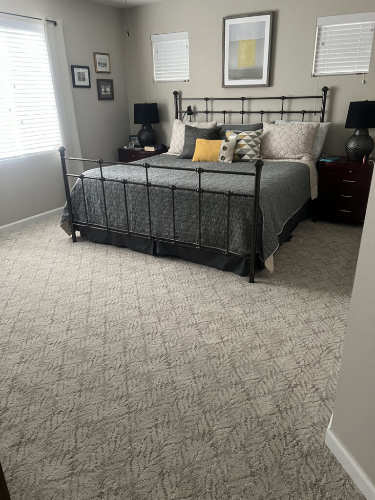 A bedroom featuring a newly installed patterned carpet by Hatloes Carpet One Floor & Home in Everett, WA.