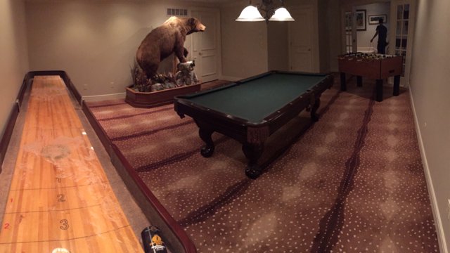 A game room featuring a unique patterned carpet installation by All Dimension Floor Care in Lenexa, KS.
