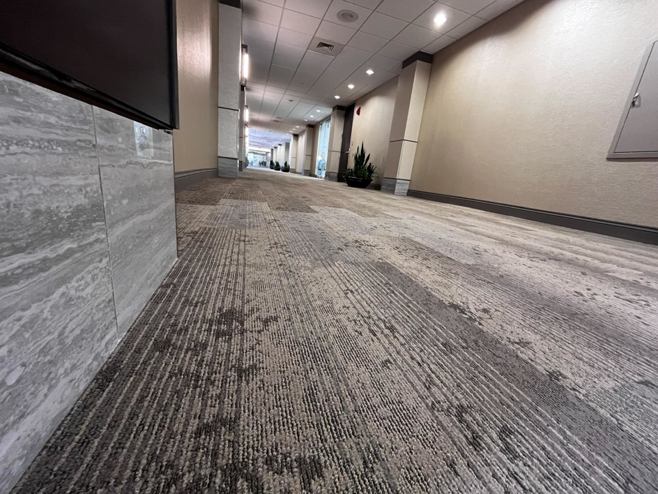 A long commercial hallway featuring new patterned carpet installed by Brothers Flooring in Spokane, WA.