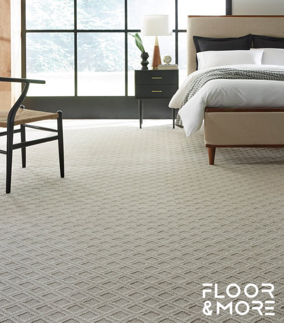 A bedroom featuring a newly installed patterned carpet by Floor & More in San Marcos, CA.