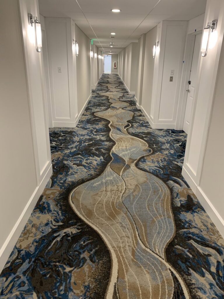 A long hallway with a unique patterned carpet installation by C&H Installation Group LLC in Schaumburg, IL
