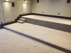 A home theater room featuring newly installed patterned carpet by Universal Flooring in Idaho Falls, ID.