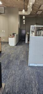 A view of newly installed patterned carpet in an office space near a window by Carpet Warehouse in Lafayette, IN.