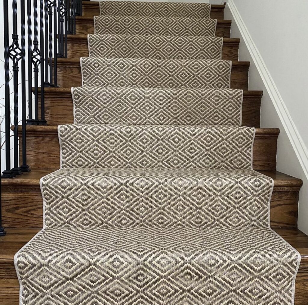 A newly installed patterned carpet runner on a wooden staircase by Floors Next Day in Austin, TX.