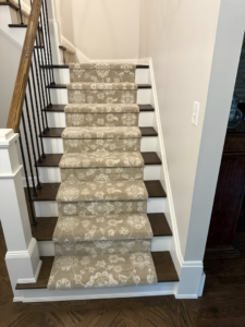 A beautifully installed patterned carpet runner on a staircase by Garrard's Flooring Service LLC in Cleveland, OH.