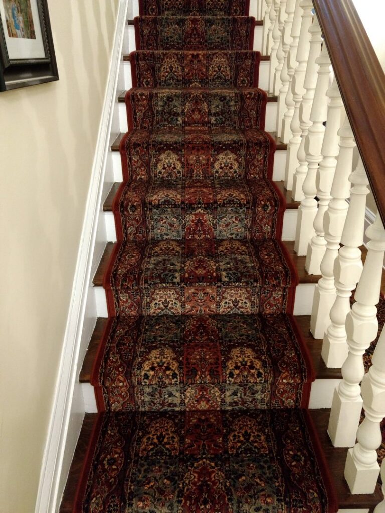 A beautifully patterned carpet runner installed on a staircase, a service provided by Home Based Carpet & Flooring in Cincinnati, OH.