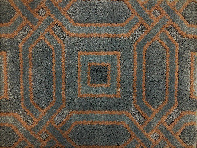 A close-up view of a blue and brown patterned carpet sample from Adda Carpet and Flooring in New Orleans, LA.