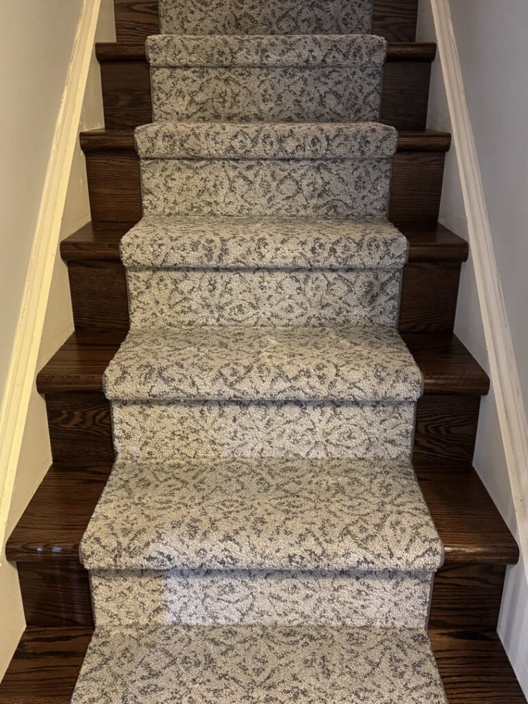 Newly installed patterned carpet on a staircase by Burkholder's Flooring America in Hagerstown, MD.