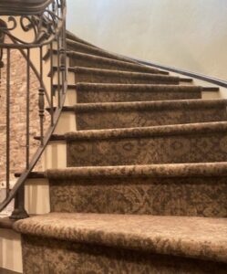 Elegant patterned carpet installed on a curved staircase by AguirreFloorz in Colorado Springs, CO.