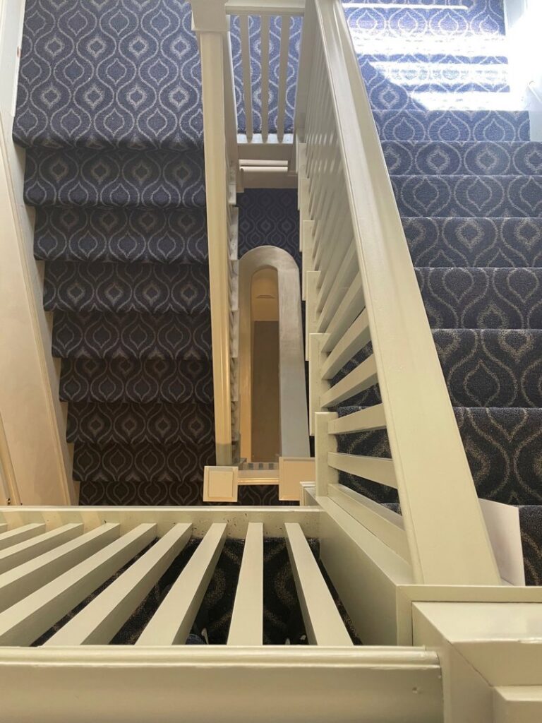 A newly installed patterned carpet on a residential staircase by Pg Long Floorcovering LLC in Portland, OR.