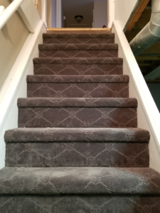 Dark brown patterned carpet installed on a staircase by Rendon Flooring in Green River, WY.