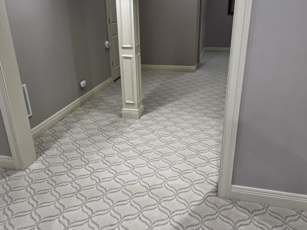 A patterned carpet installation in a hallway leading to stairs by Kevin's Carpets of Lexington and Georgetown, KY.