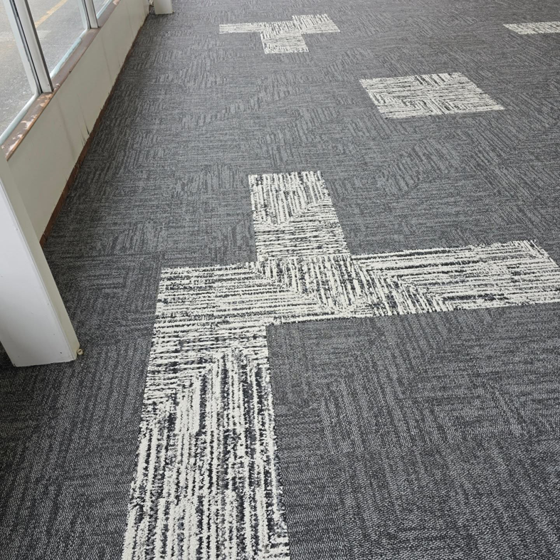 Stylish patterned grey and white carpet tiles installed by LaValle Flooring Inc - Valley City in Valley City, ND.