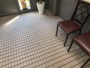 A clean patterned commercial carpet in a room with chairs, serviced by Clear Vision Carpet & Floor Care, Inc. in Newnan, GA.