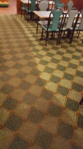 Patterned commercial carpet cleaning in a restaurant, showing a clean and dirty section, by Keith's Cleaning Service in Auburn, ME