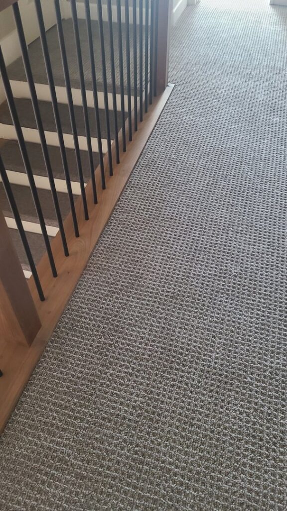 A hallway featuring newly installed patterned carpet by the expert team at Floors by Aldaba LLC in North Las Vegas, NV.