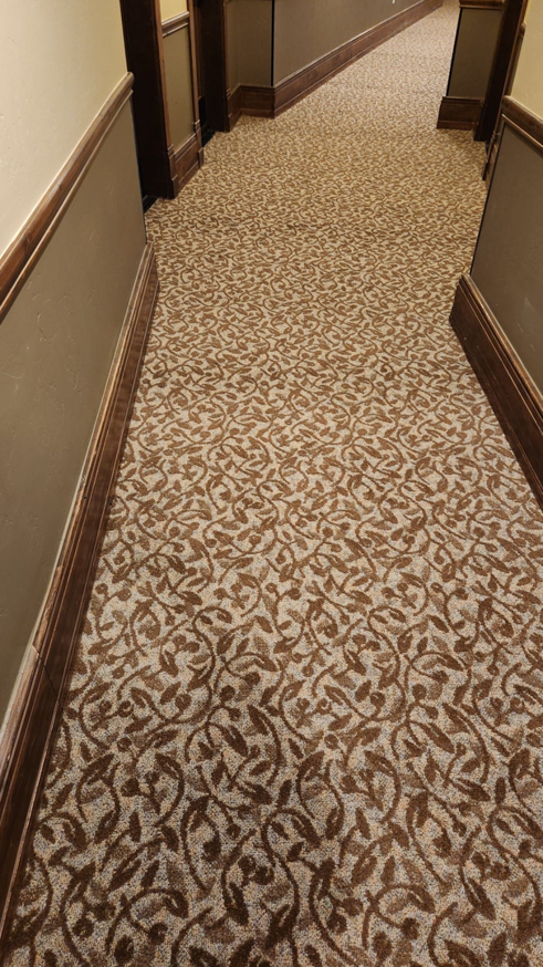A hallway featuring a newly installed patterned carpet by A Floor For You, a carpet contractor in Denver, CO.